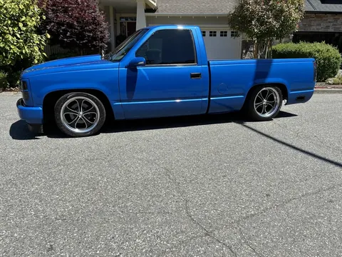 Amazon customer blue pickup truck with bright paint reflections